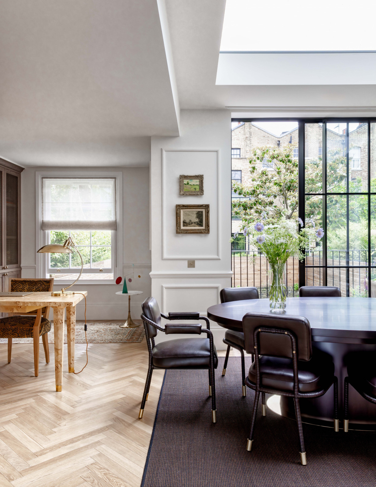 Parquet-style timber flooring introduces warmth and tactility underfoot