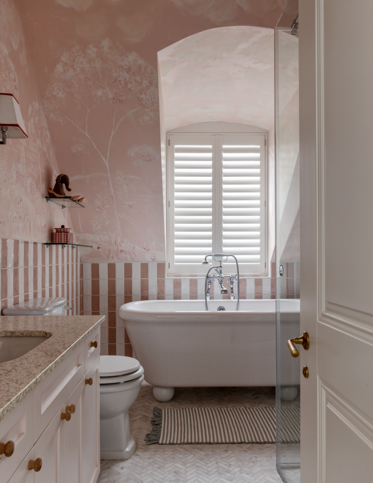 The pink bathroom for the daughters is playful and full of personality