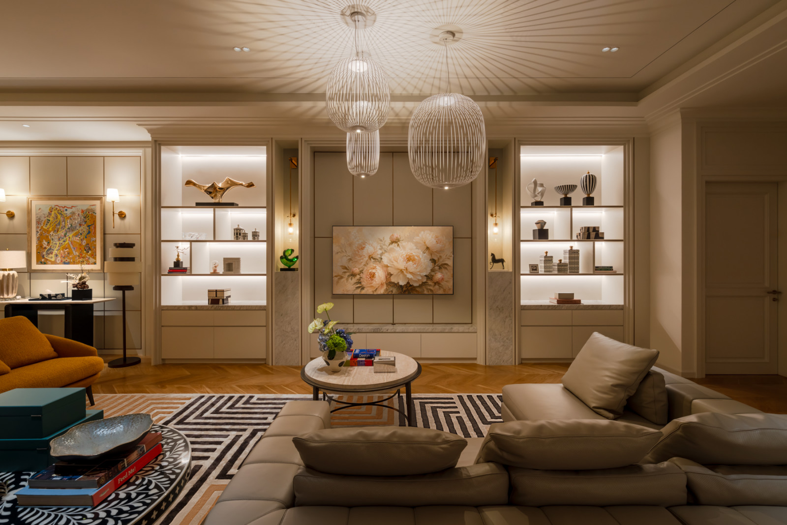 Backlit display shelving flanks the television wall in the media room, hung with a floral painting