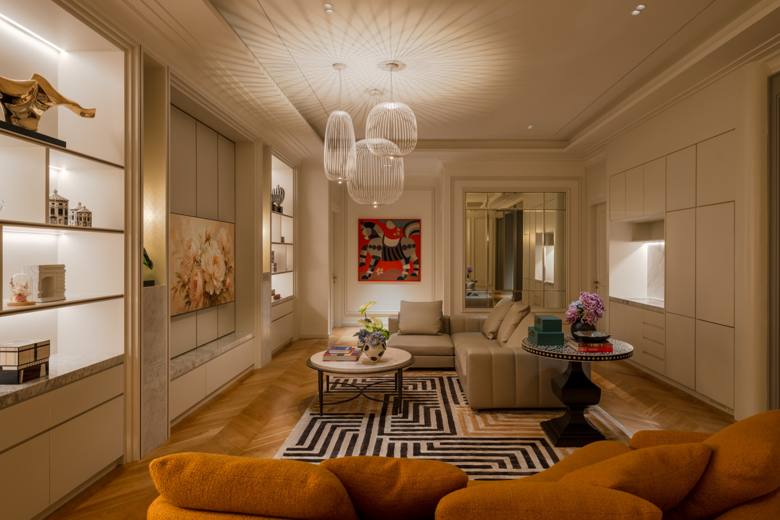 Orange upholstered seating and a graphic black-and-white rug furnish a smaller sitting room off the main living areas