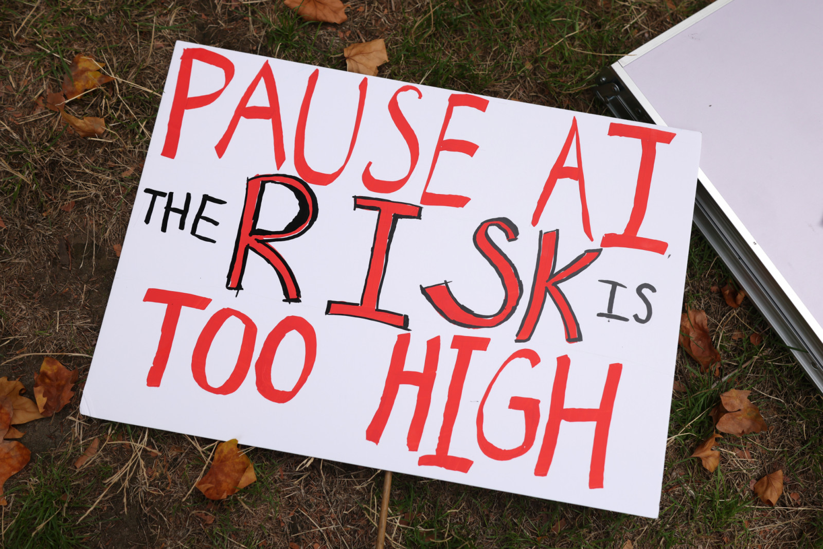 LONDON, ENGLAND - SEPTEMBER 16: A placard reading 'Pause AI the risk is too high' is seen on the ground on Whitehall near Downing Street on September 16, 2026 in London, England. PAUSE AI are asking the government to listen to the people and consider the dangers of AI. They say there are real-life harms of AI, including amplifying biases, spreading widespread misinformation, consolidating power among elite tech companies, and straining public infrastructure, housing, and utilities. Recent incidents they hig