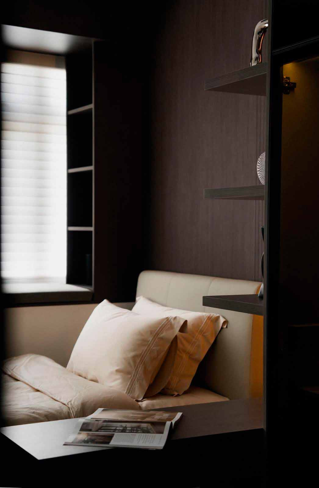 This compact bedroom integrates a study and storage