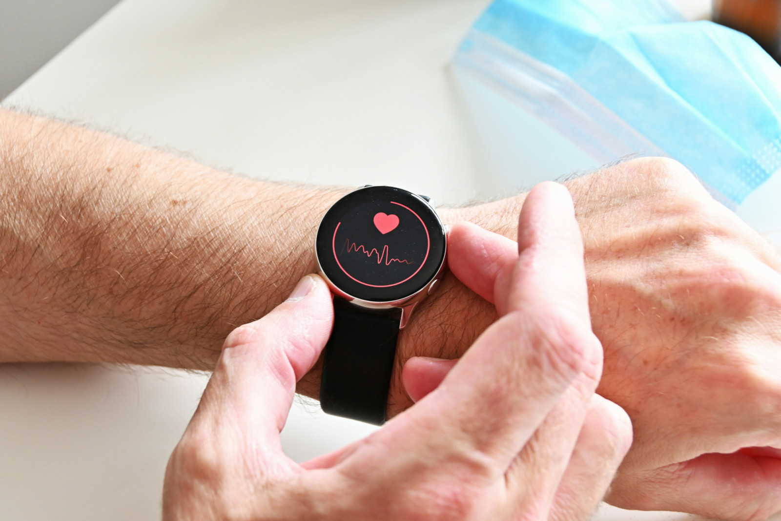 A person uses a smartwatch to monitor their heart rate, reflecting a proactive approach to wellness.