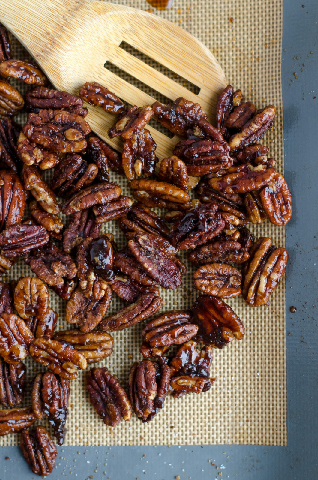 Sweetly glazed pecans on a baking mat showcase a flavorful nut often used in desserts.