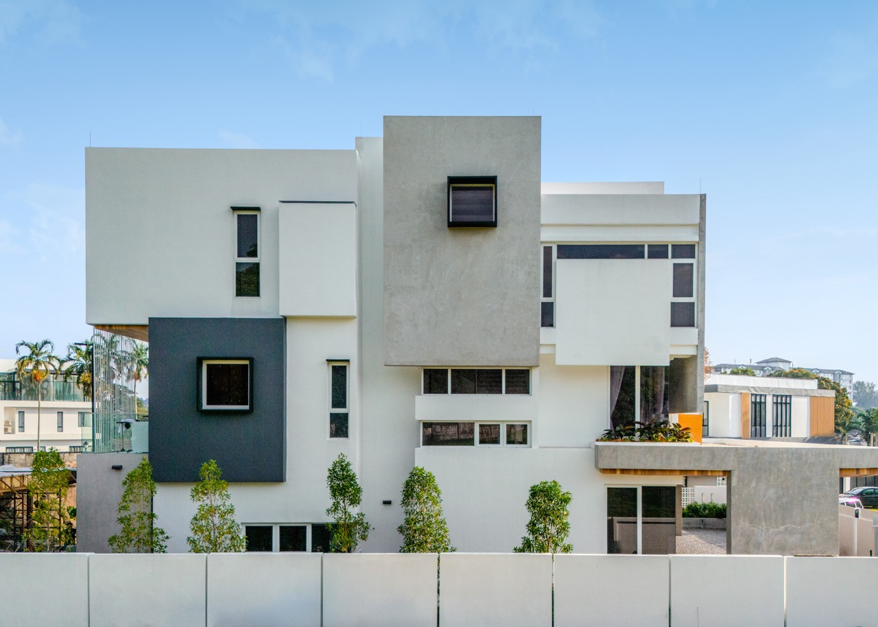 The rear of the house, facing west toward the pond, features cubic volumes designed to manage heat gain while preserving the view