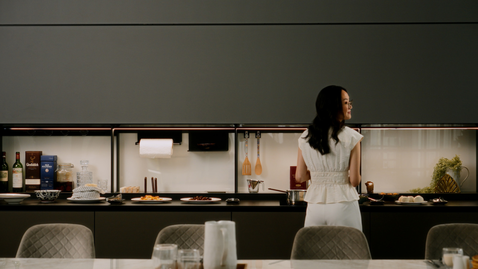 Melissa Yuen at the indoor kitchen next to one of the home’s dining rooms