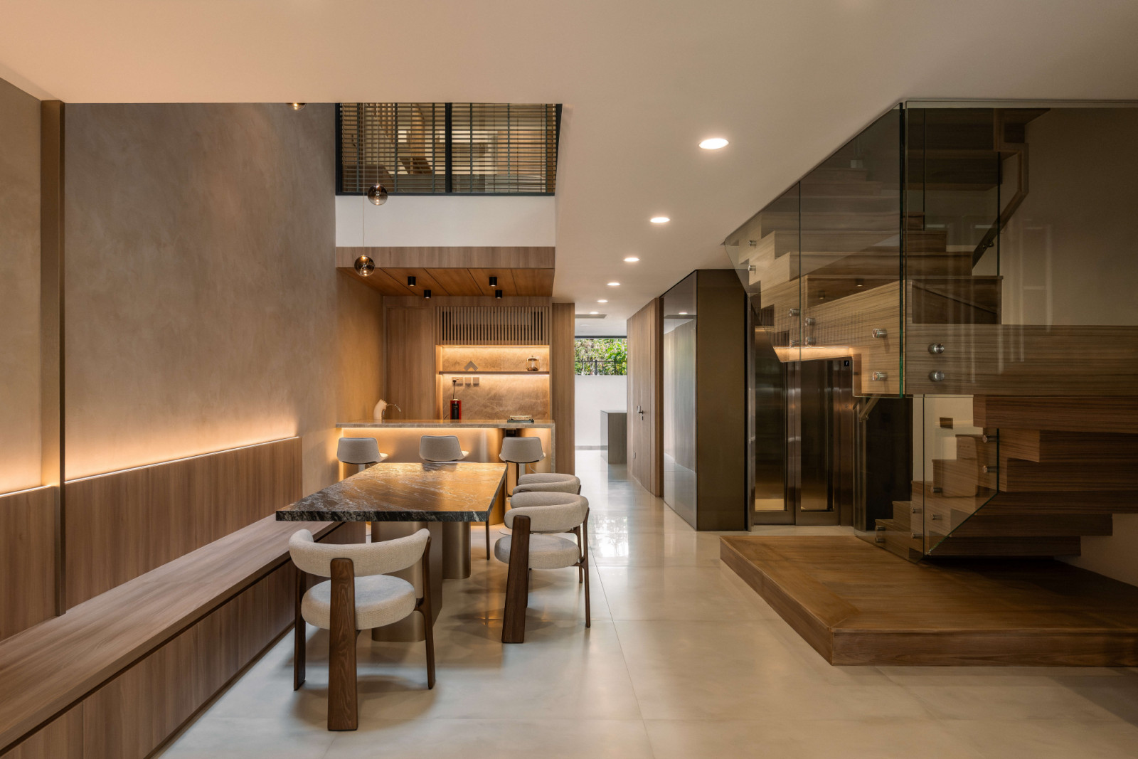 The dining table sits under a dramatic skylight