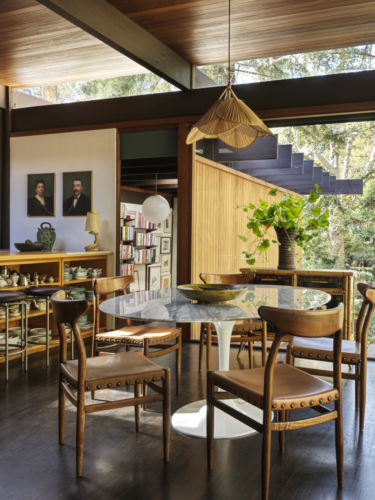 The breakfast Nook overlooking the backyard; the home office can be seen in the background through the open doorway of a California home designed by Kate Driver of West Haddon Hall