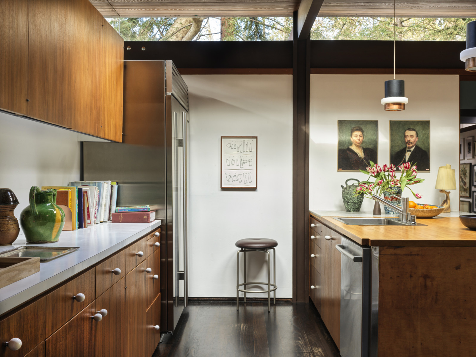 The chef’s kitchen overlooking the split-level home office of a California home designed by Kate Driver of West Haddon Hall