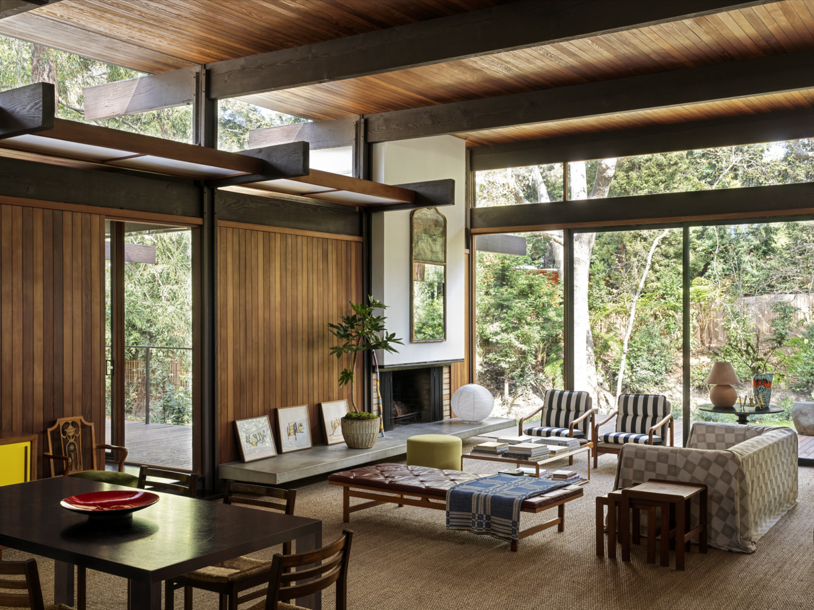 The open living space overlooking the backyard and creek of a California home designed by Kate Driver of West Haddon Hall