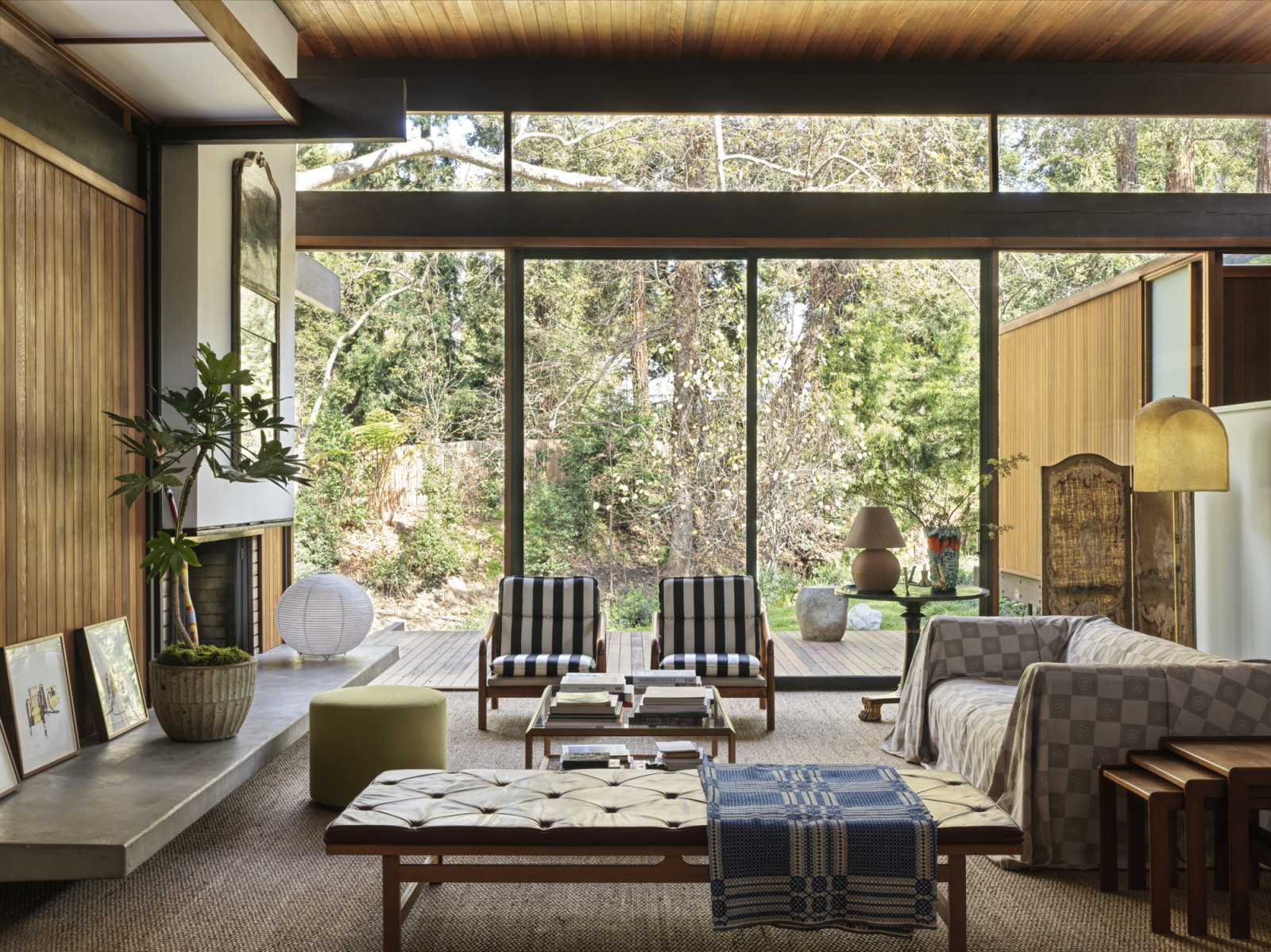 The open living space overlooking the backyard and creek of a California home designed by Kate Driver of West Haddon Hall