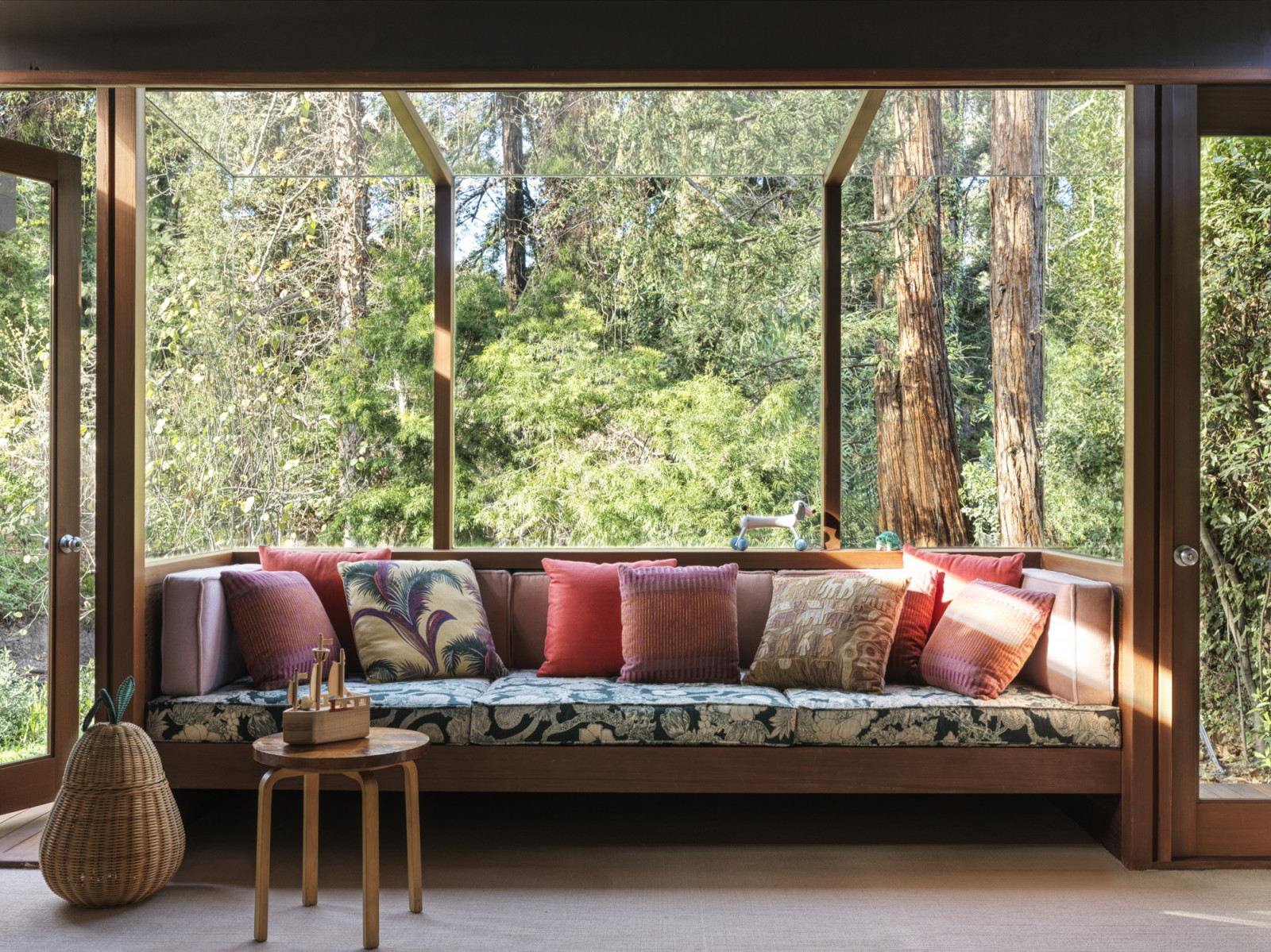 The built-in window seat overlooking the backyard creek in the California home designed by Kate Driver of West Haddon Hall