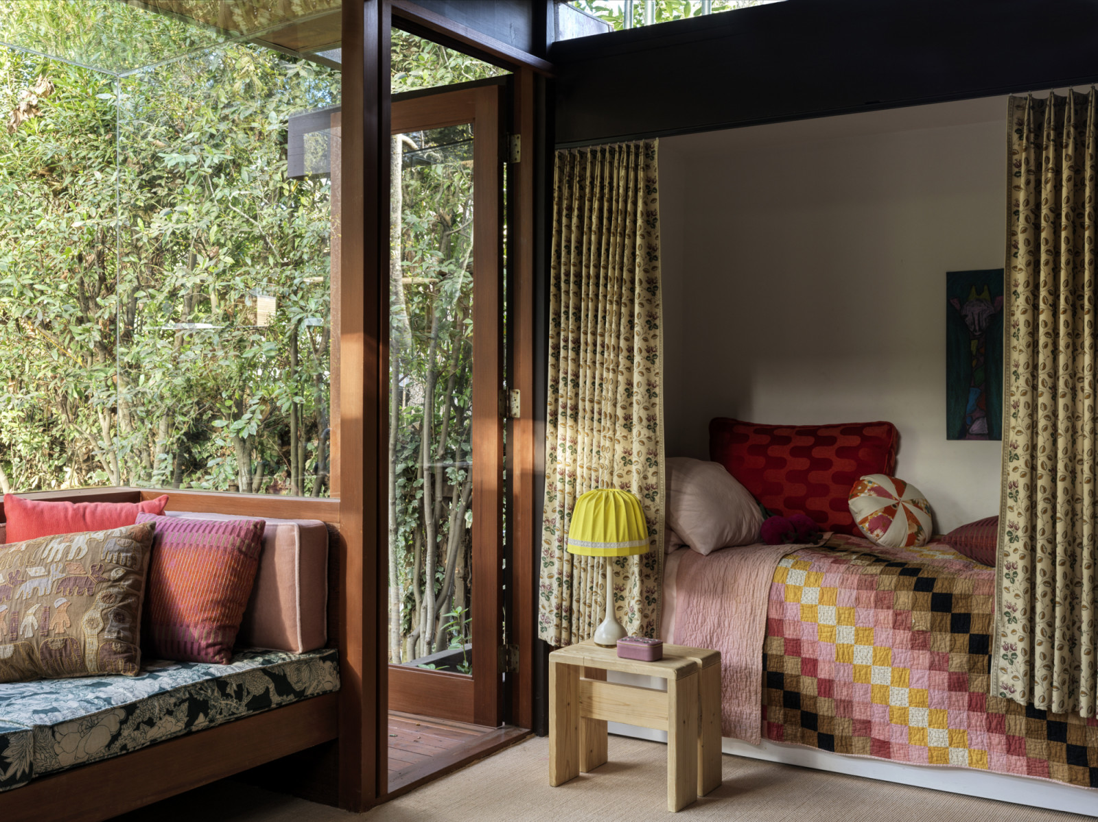 The built-in bed nook and window seat in the California home designed by Kate Driver of West Haddon Hall