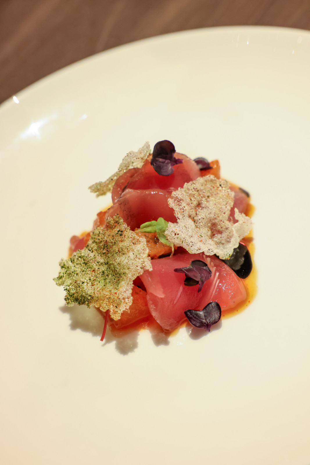Chef Josh Boutwood of Helm prepared refreshing raw tuna, lightly smoked over hay, with sourdough miso, ponzu and kimchi pear | Off Menu 2026