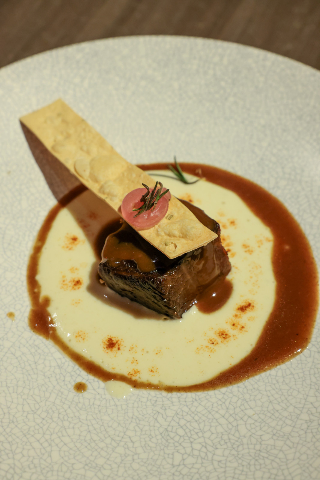 From Raging Bull Chophouse & Bar, chef Loïc Brun prepared a tender 36-hour slow-braised beef short rib with creamy raifort foam, smoked pickled shallots and Raging Bull bourbon jus | Off Menu 2026
