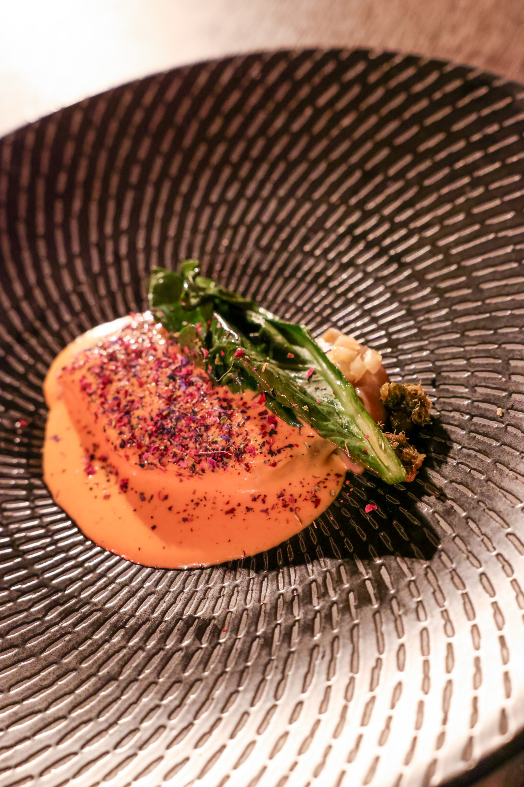 Chef Charles Montanez of Liyab created a dish of aged cobia fish with burnt santol wood butter, fermented red pepper and mango beurre blanc, kale and sweet pickled ginger | Off Menu 2026