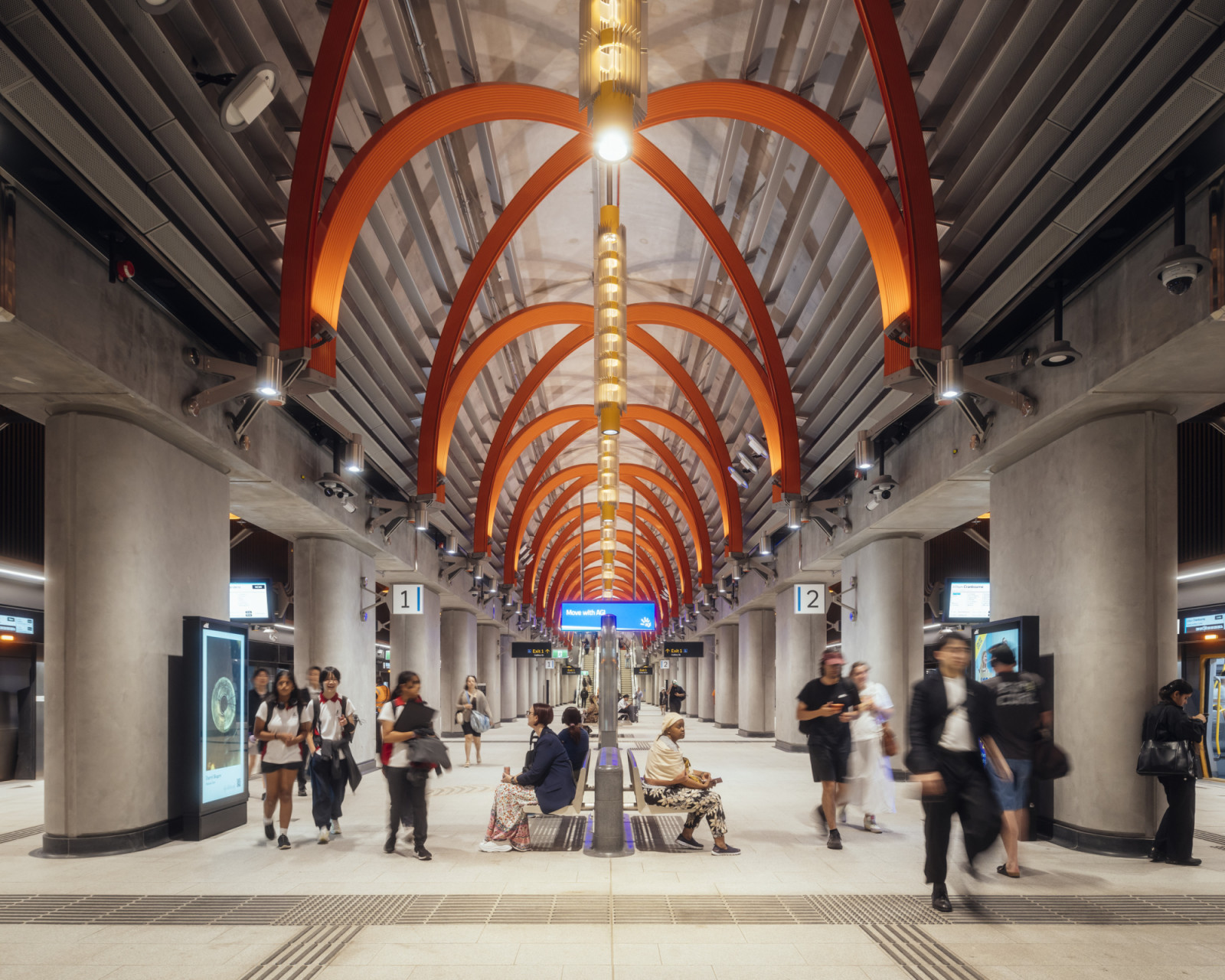 Orange-red ribs arch over the platforms at Town Hall Station, with a column of pendant lights running along the centre of the Melbourne station (Photo: Jim Stephenson)