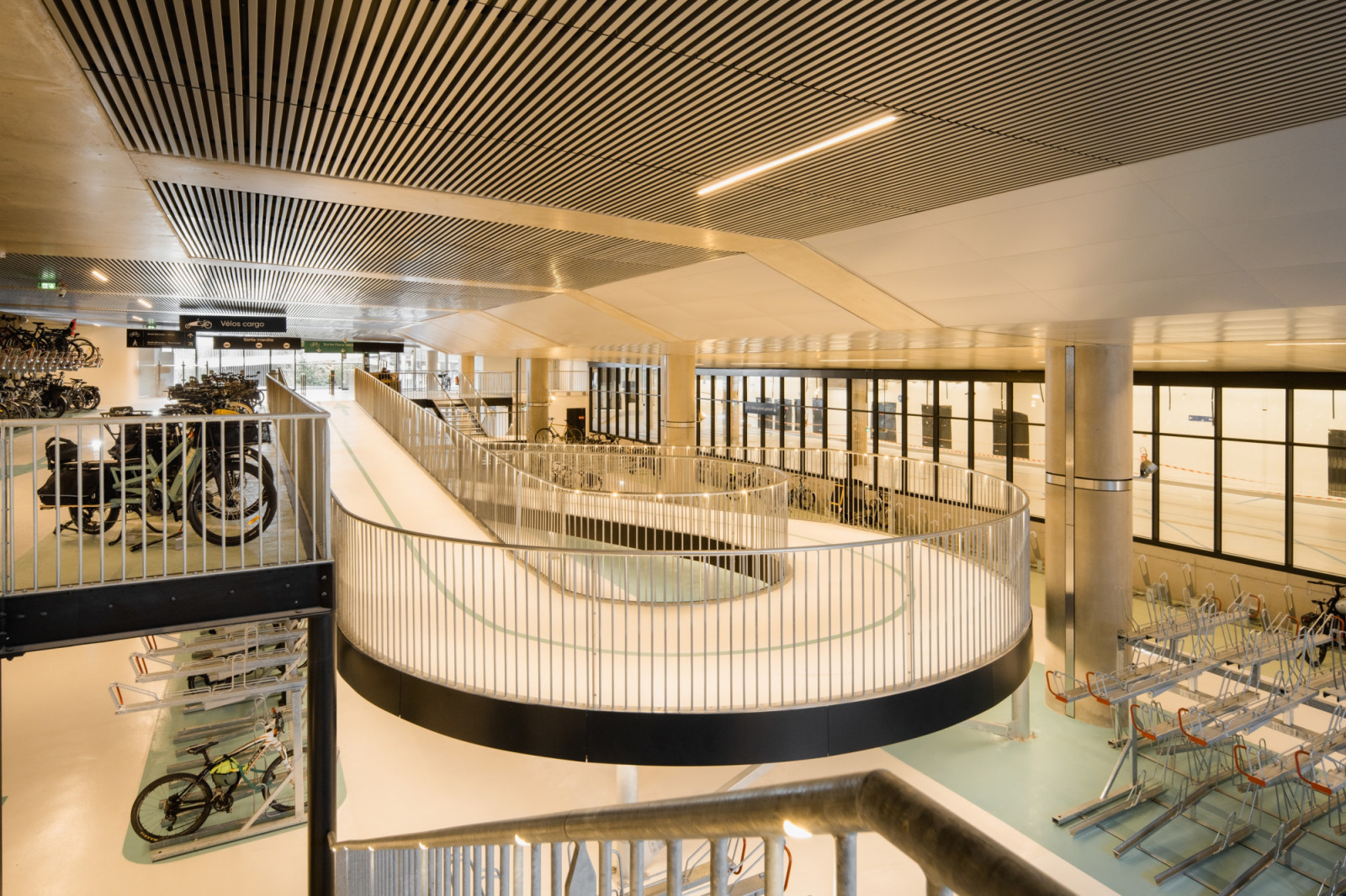 A looping ramp connects the levels of the bicycle parking garage beneath Place Charles Béraudier, France’s largest, with separate bays for cargo bikes (Photo: Romuald Nicolas)