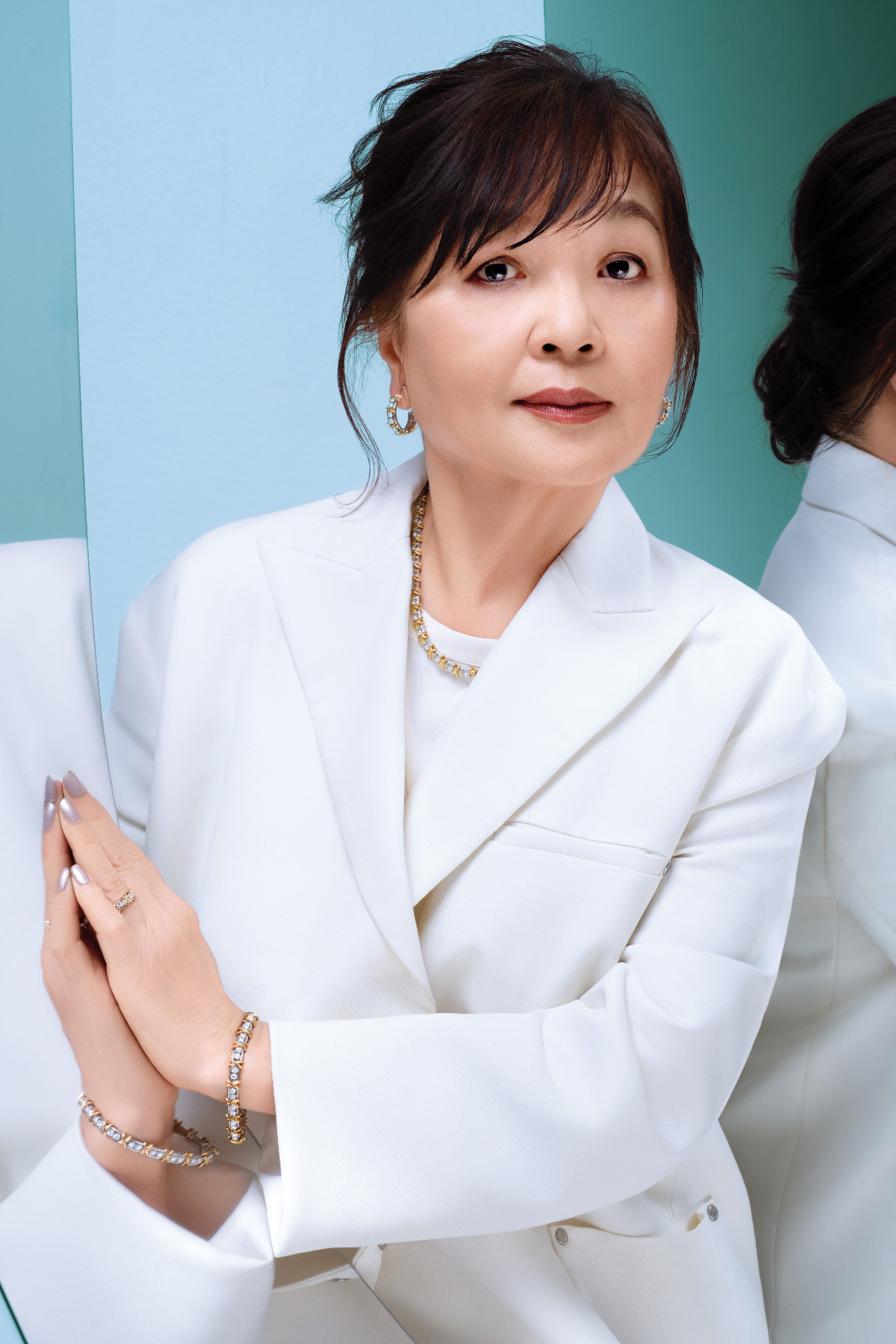 Min Caunter wears Tiffany & Co. Sixteen Stone earrings, necklace, bracelet and ring, Longchamp blazer