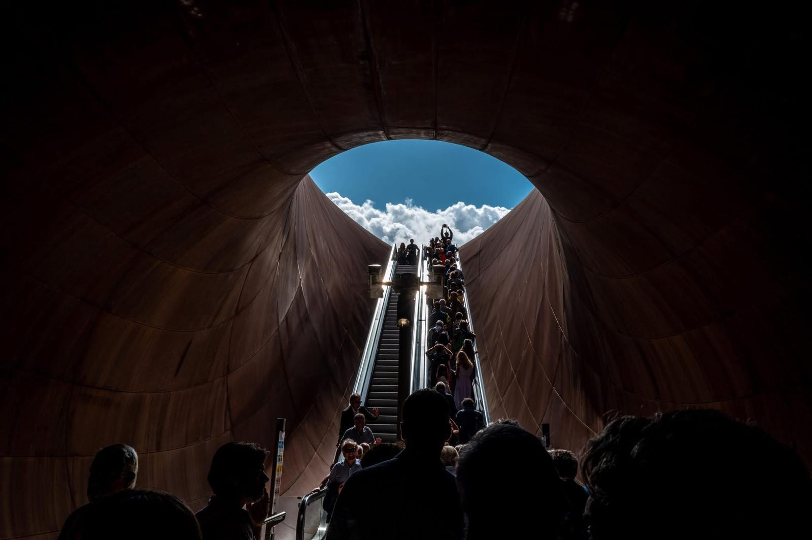 Below ground, an escalator and staircase run beneath the deliberately rough walls and ceiling of Monte Sant’Angelo Station in Naples (Photo: Mallardo)