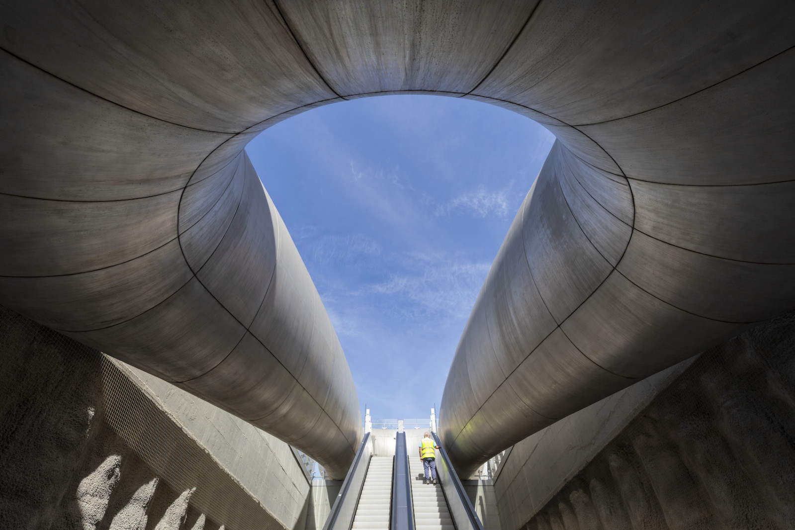 Passengers ride the escalators up through the corten steel entrance of Monte Sant’Angelo Station towards the sky in Naples (Photo: @Anish Kapoor)