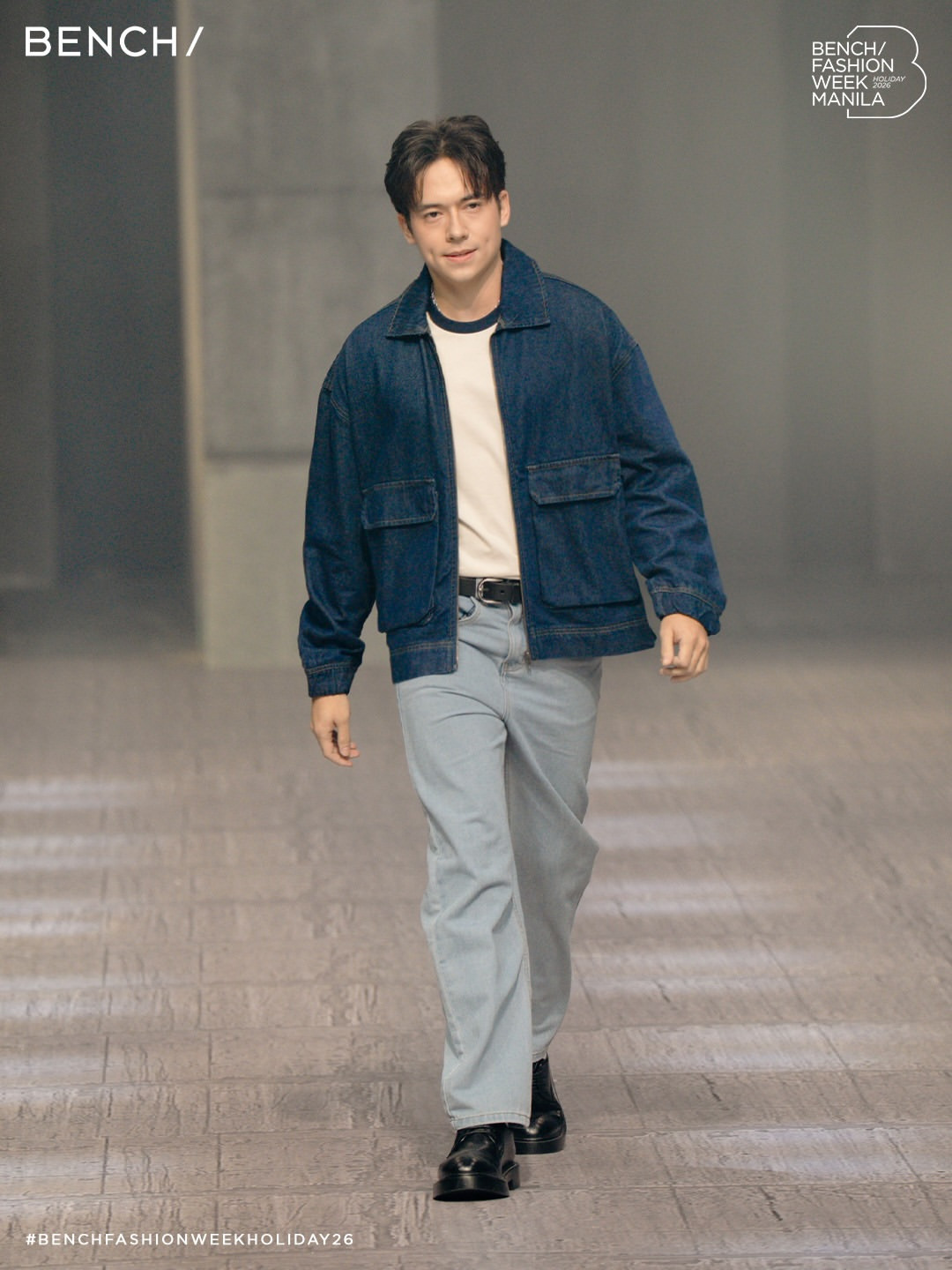 A model sports a denim jacket and light-wash jeans for Bench's Holiday 2026 collection at Bench Fashion Week Manila.