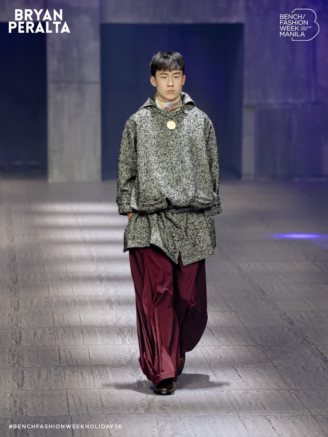 A model showcases a design from Bryan Peralta's Holiday 2026 collection