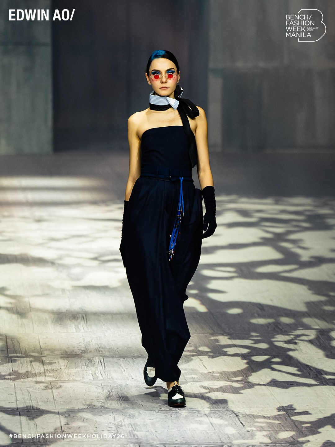 Edwin Ao's Holiday 2026 collection for Bench Fashion Week Manila presents a strapless ensemble paired with distinctive red eyewear