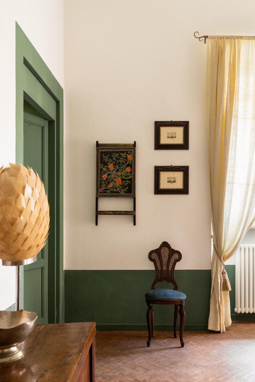 Green wainscot continues through the door linings and doors, paired with original Herringbone terracotta flooring