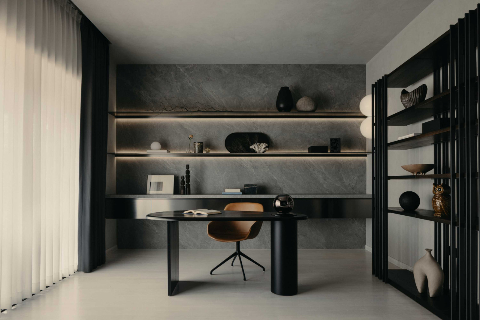 Created by repositioning the junior master bathroom, the attic study features gently backlit shelves and a sculptural desk