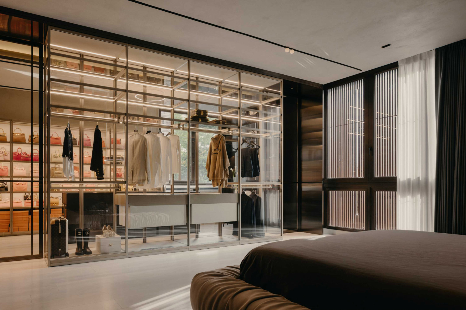 The walk-in wardrobe’s Poliform joinery displays exotic-range handbags and jewellery