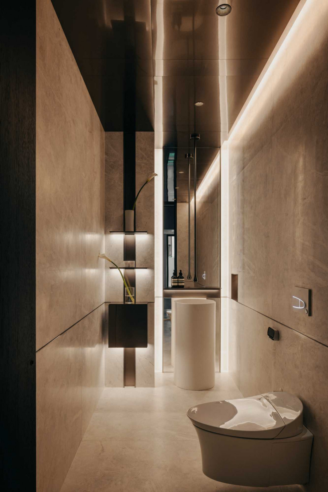 This bathroom’s stone walls and backlit niche give it a distinct look