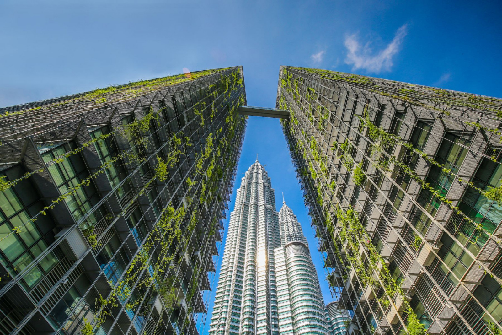 A skybridge links the two towers of Le Nouvel KLCC, designed by Jean Nouvel, with the Petronas Twin Towers rising between them