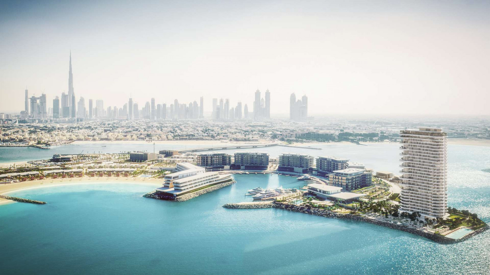 A rendering of Jumeirah Bay Island in Dubai, where the Bvlgari Lighthouse residential tower rises at the island’s tip beside the Bvlgari resort and marina, with the Burj Khalifa beyond (Photo: Meraas)