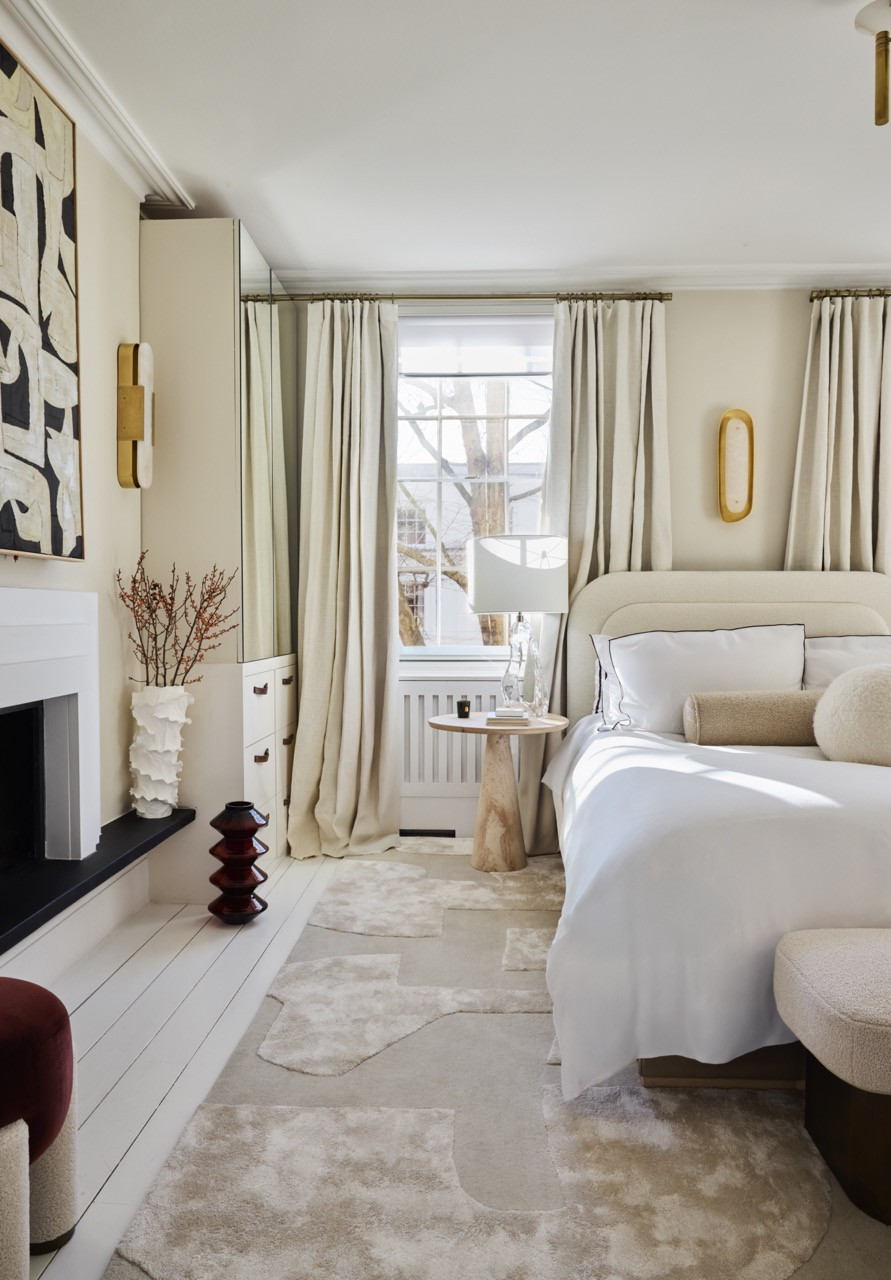 The main bedroom, where long linen curtains, one of Huang’s go-to touches, soften the windows above white-painted floorboards and an abstract rug