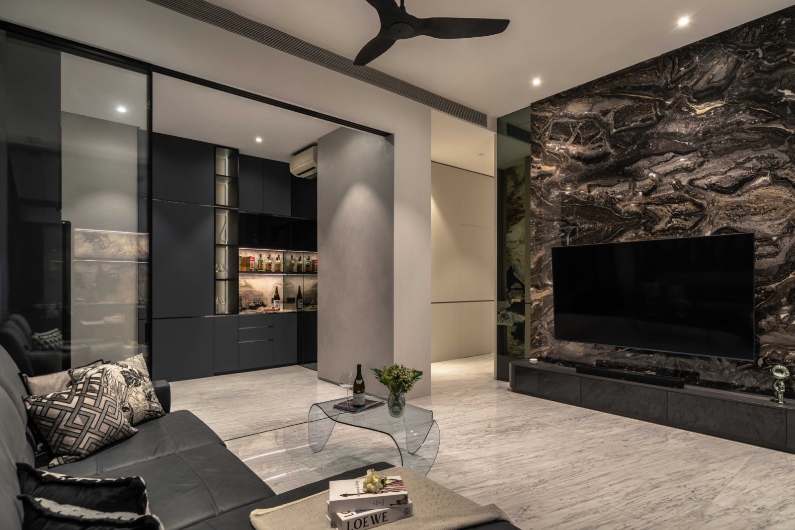 Another view of the living area on the first floor, anchored by a striking feature wall