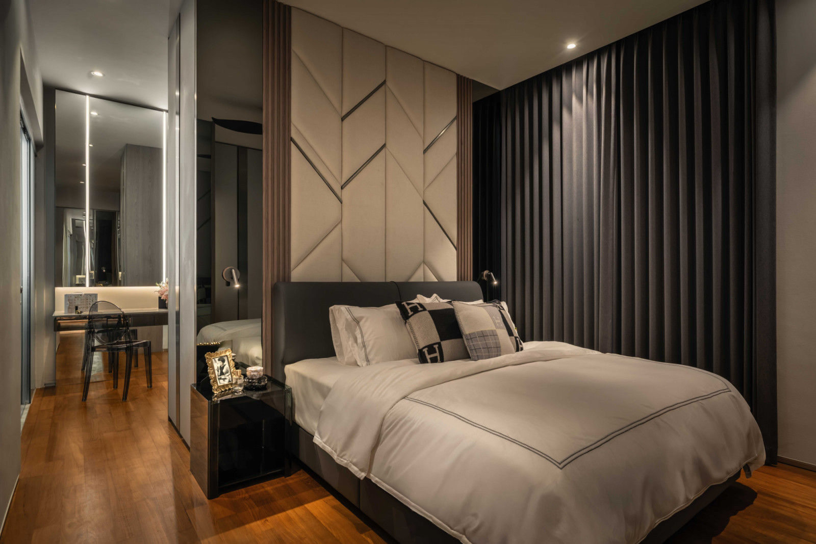 The master bedroom incorporates tasteful storage solutions that are inconspicuously tucked into walls and corners