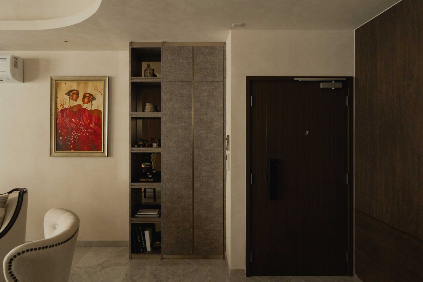 The splash of red in this artwork marks a rare foray into colour amid the otherwise neutral scheme