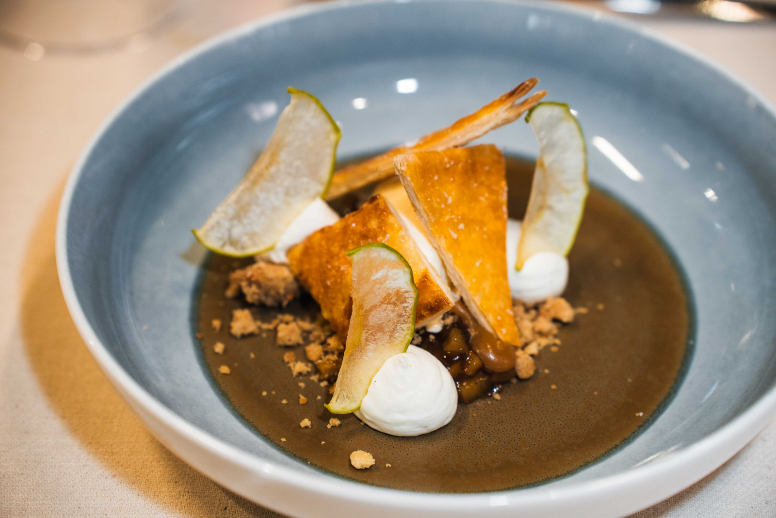 Deconstructed tarte tatin with caramelised apple, puff pastry, walnut, and Tahitian vanilla and sour cream ice cream