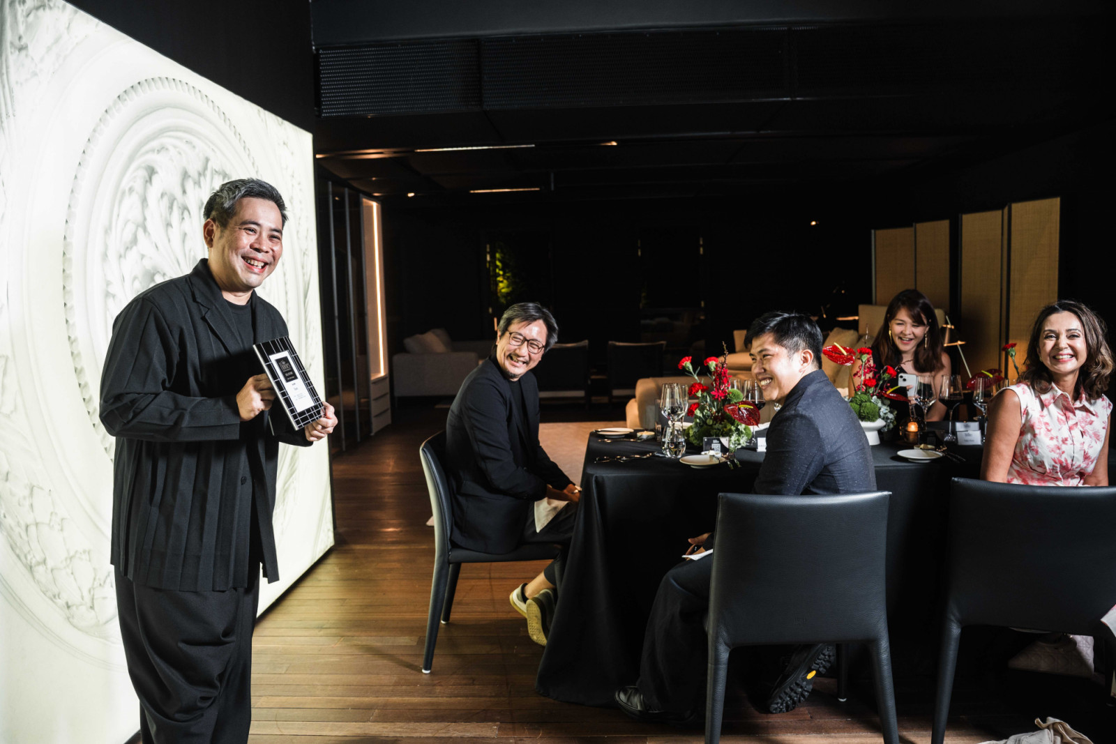 Selwyn Low of Farm opening his speech as Tiah Nan Chyuan, seated, shares a laugh