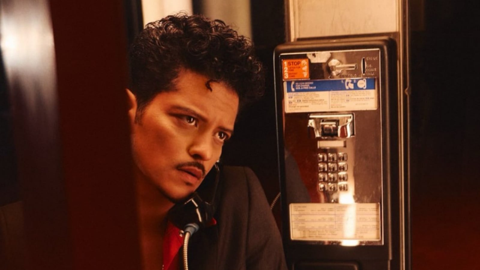 Bruno Mars, the Grammy-winning artist, makes a call from a payphone.