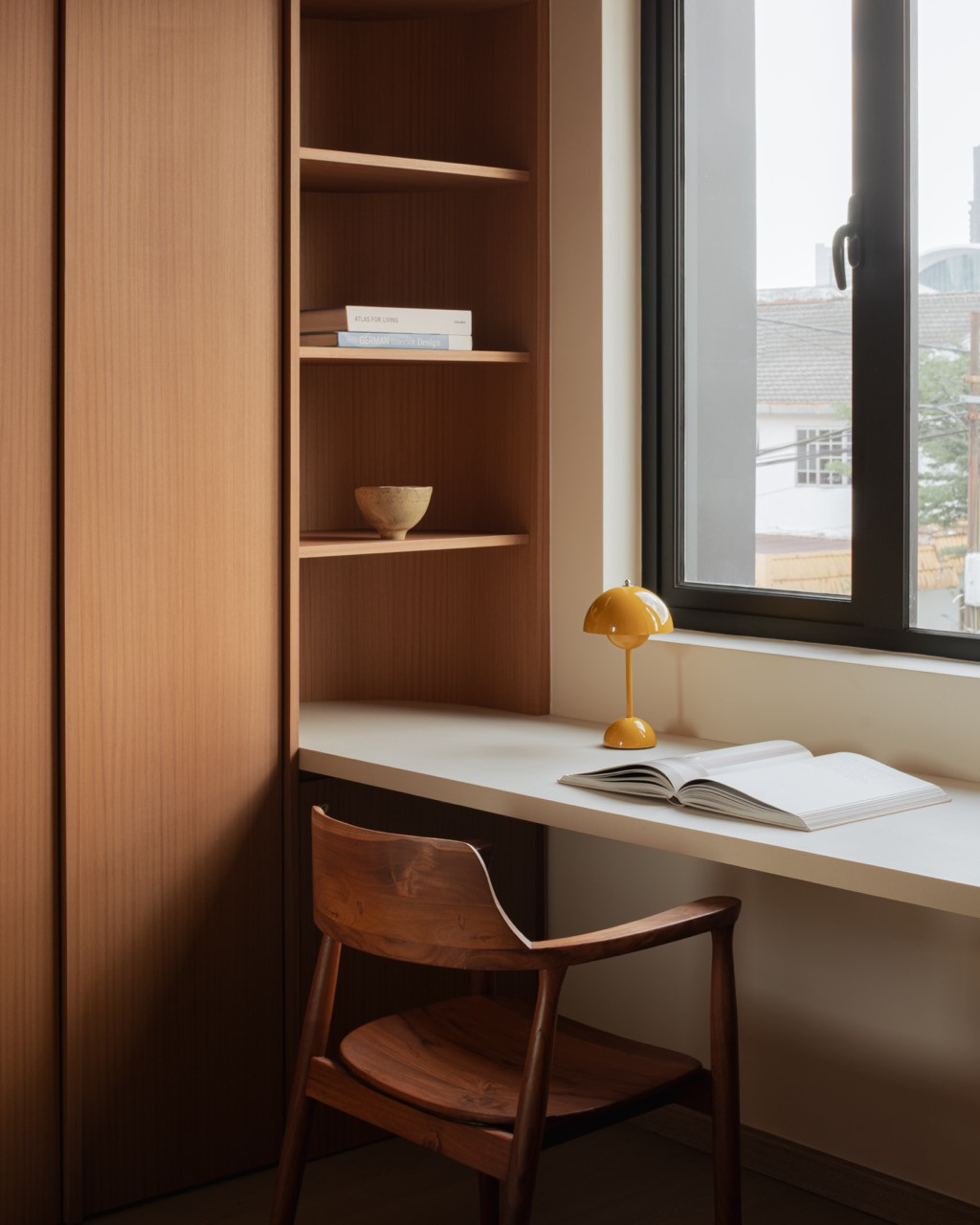 A Verner Panton table lamp stands on the built-in desk in the study, which faces the street
