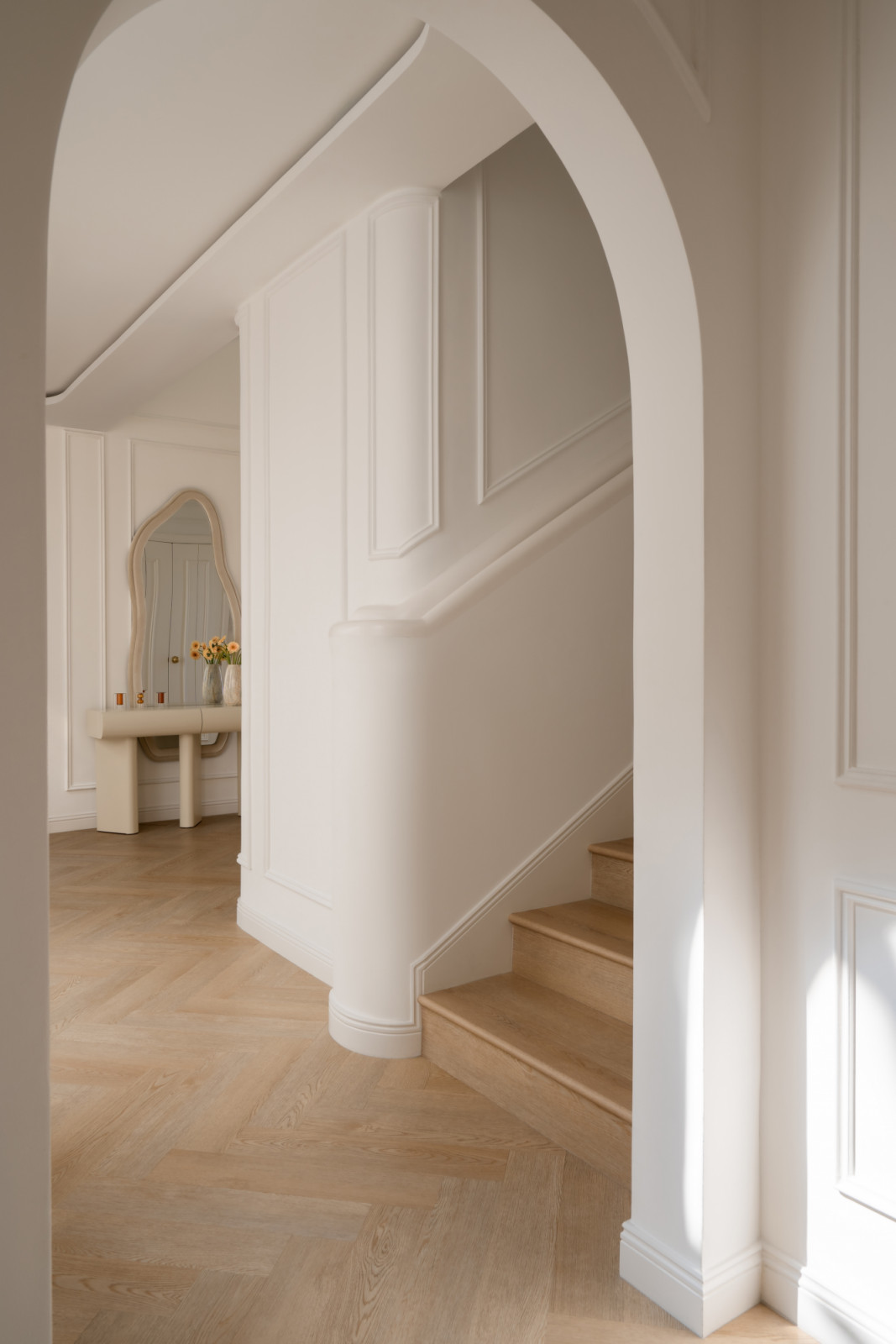 The home is built around layered whites, soft neutrals, beige and warm browns