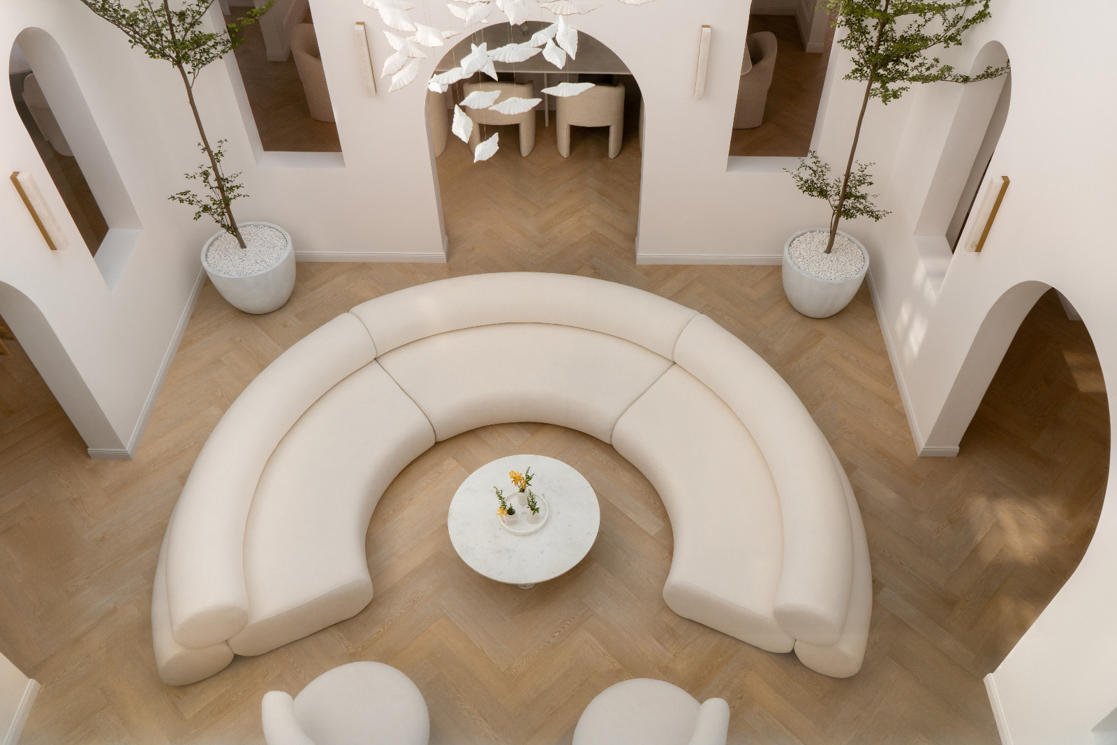 The bespoke C-shaped DOT Objects sofa gently embraces the courtyard, complementing the curvature of the surrounding arches