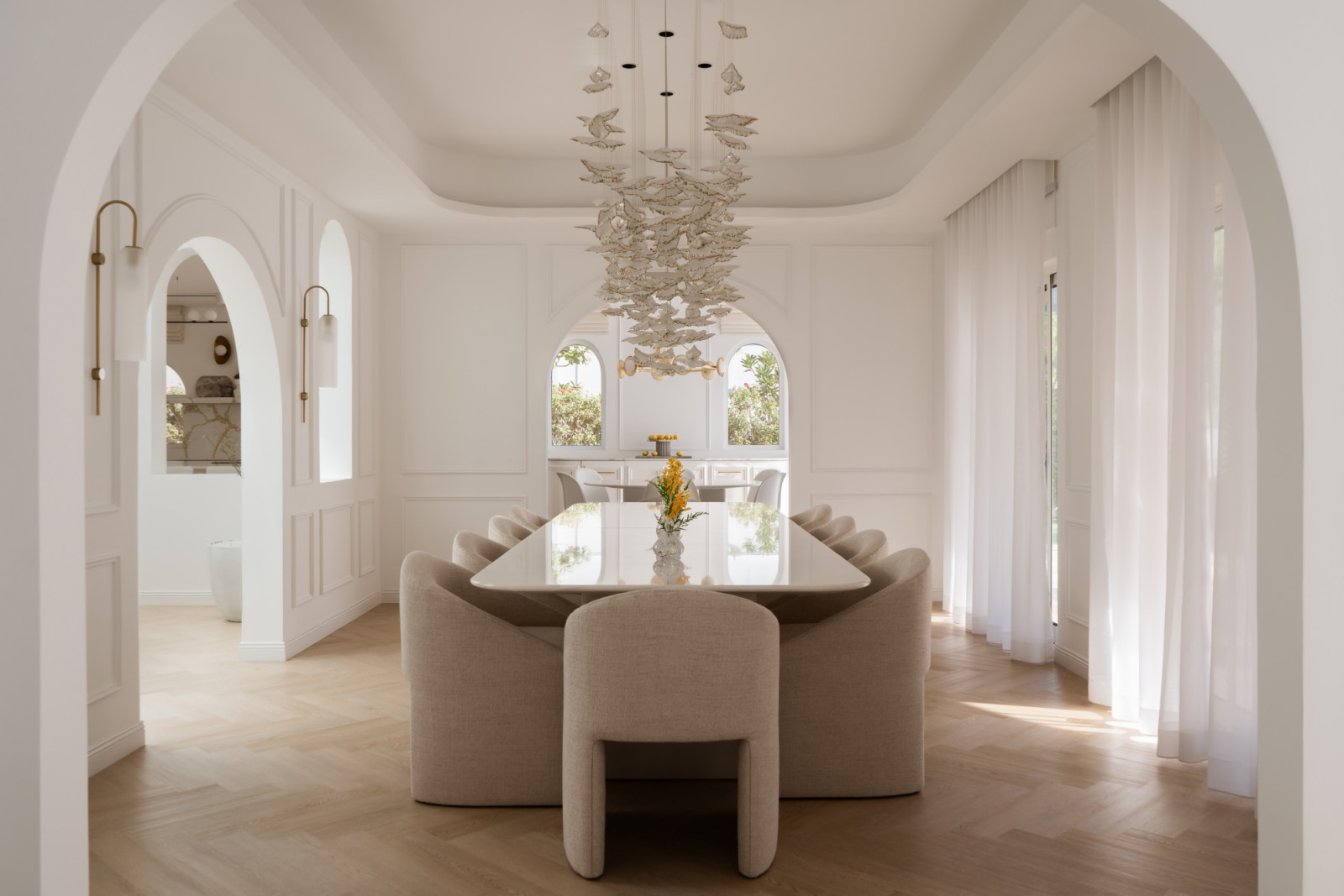 The dining room with picture-frame wall mouldings, light oak herringbone flooring
