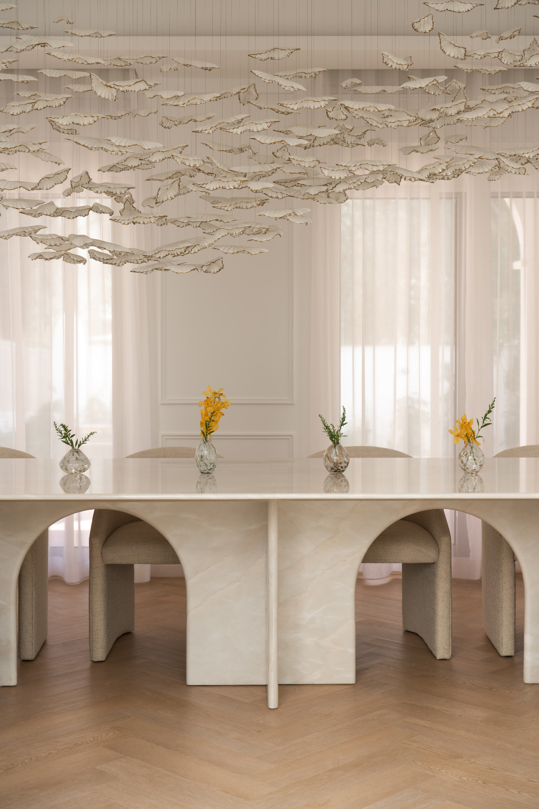 A bespoke white onyx formal dining table by DOT Objects by D’Ora Tokai Designs