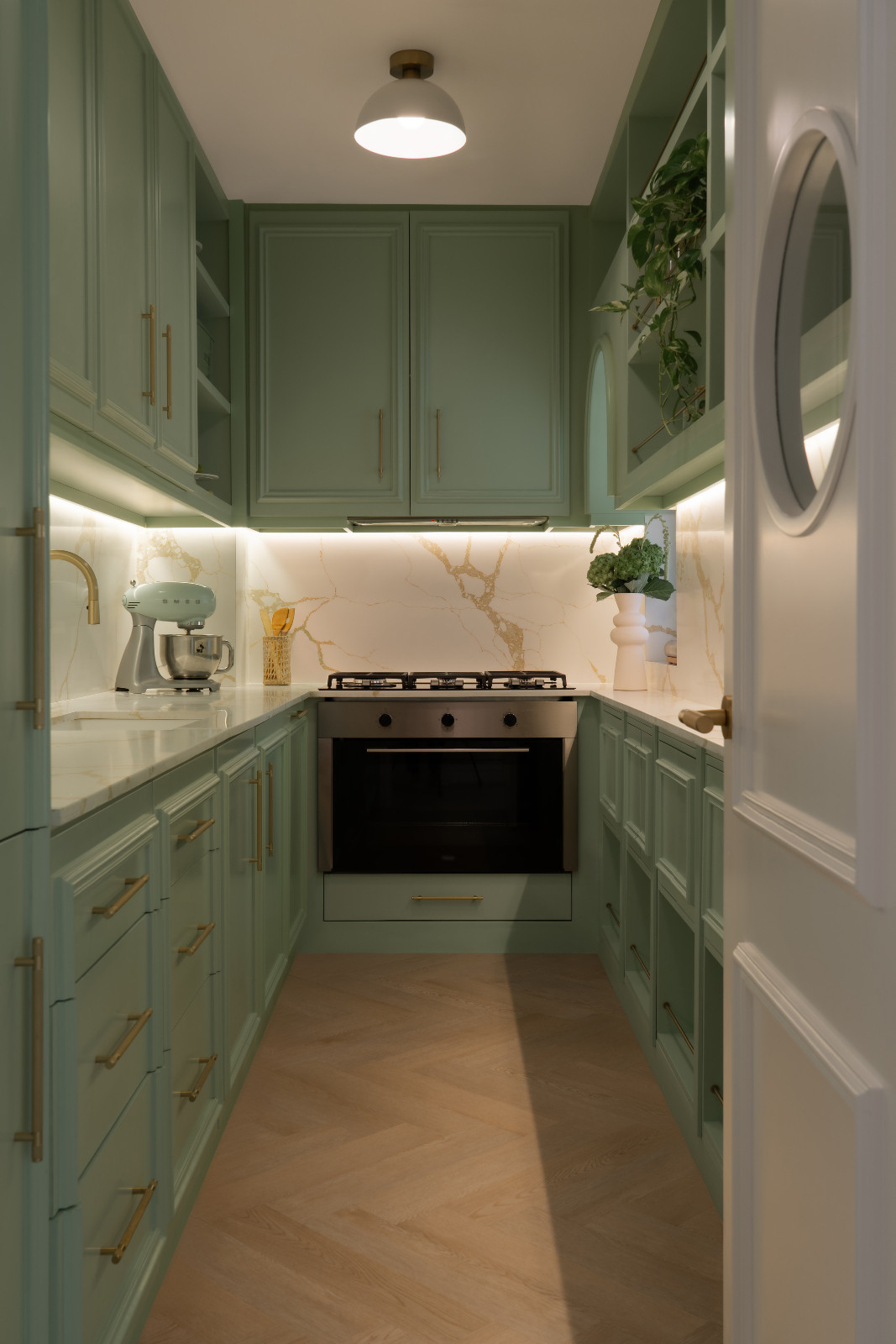 The sage green preparation kitchen adds freshness, and a subtle connection to nature