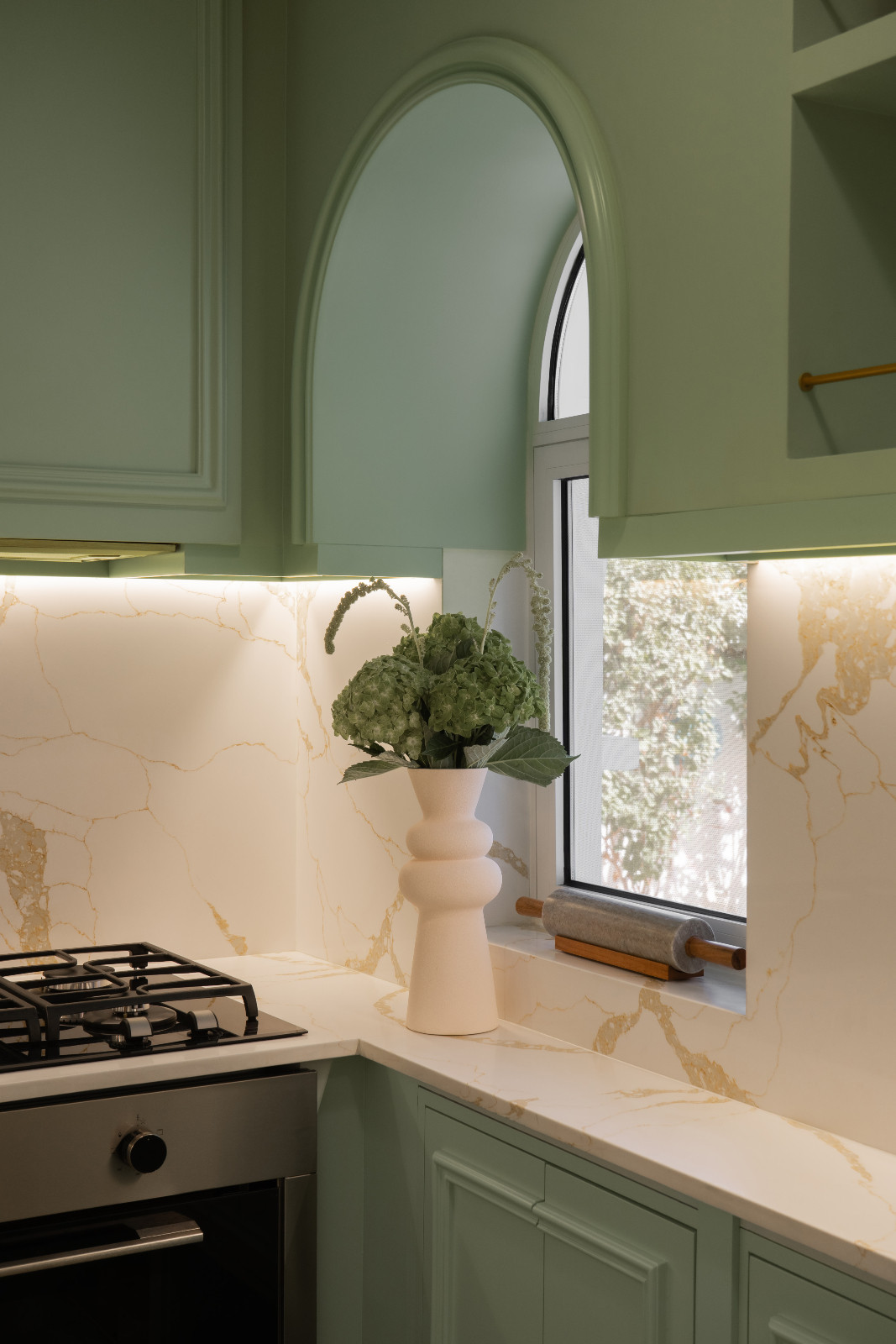 A curved window adds a hint of playfulness to the practical functionality of the space
