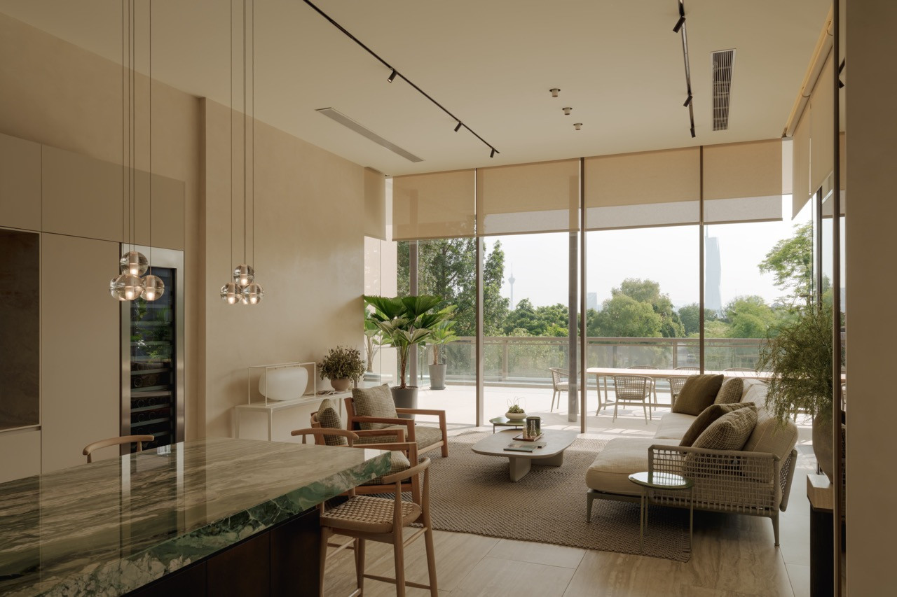 The living area, furnished with pieces from B&B Italia by Antonio Citterio sourced through the collaboration with Space Group, opens onto a private terrace with the Kuala Lumpur skyline in view