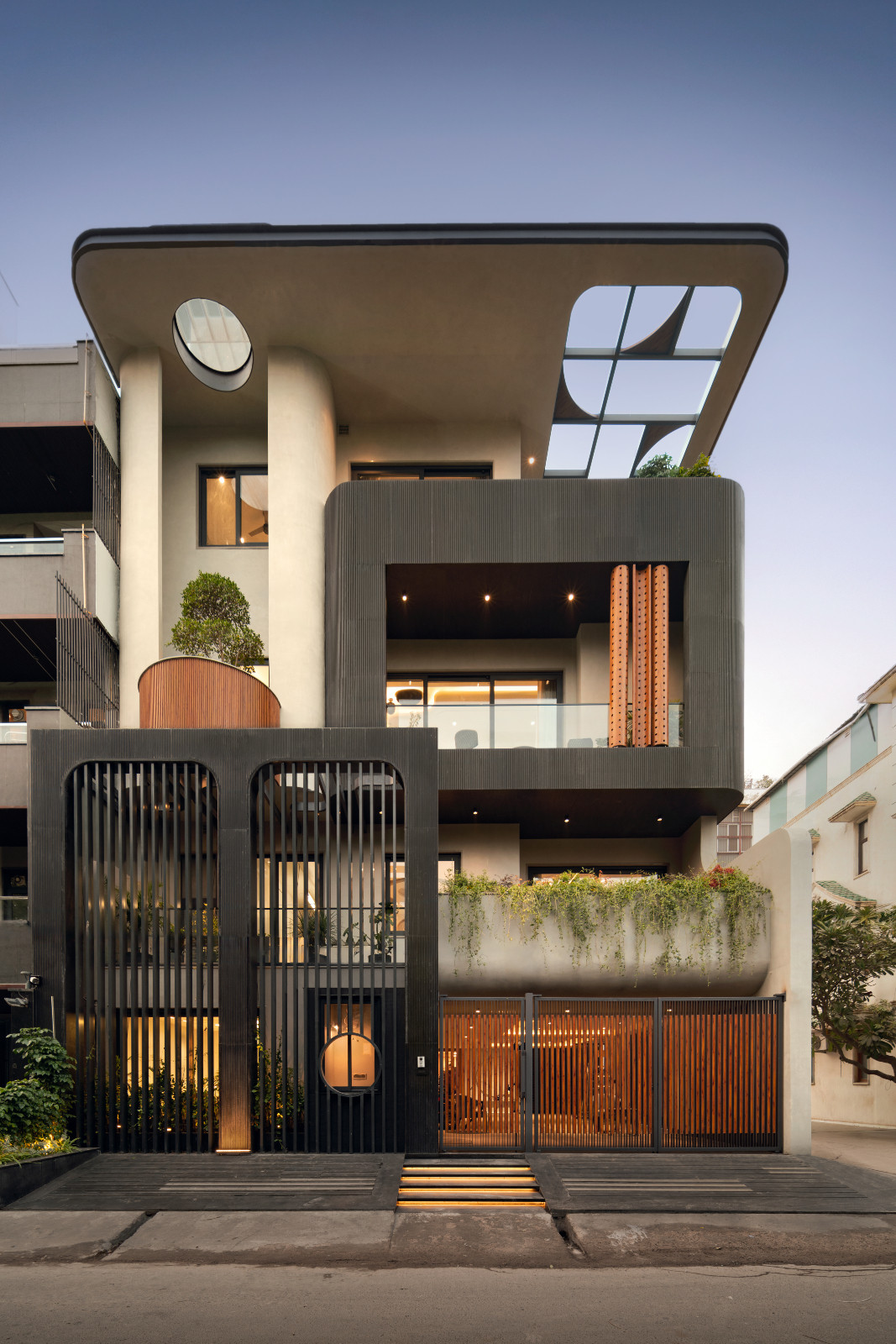 An external shot of an avant-garde family home with brutalist elements in New Delhi, India designed by Spaces Architects @KA
